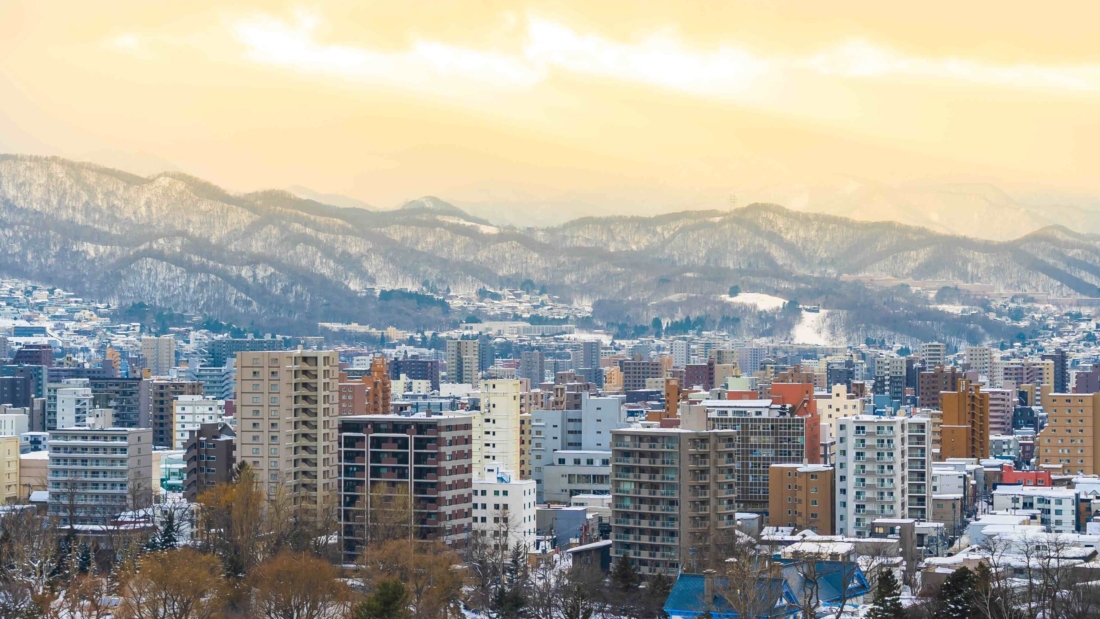 Beautiful architecture building with mountain landscape in winter season at sunset time Sapporo city Hokkaido Japan