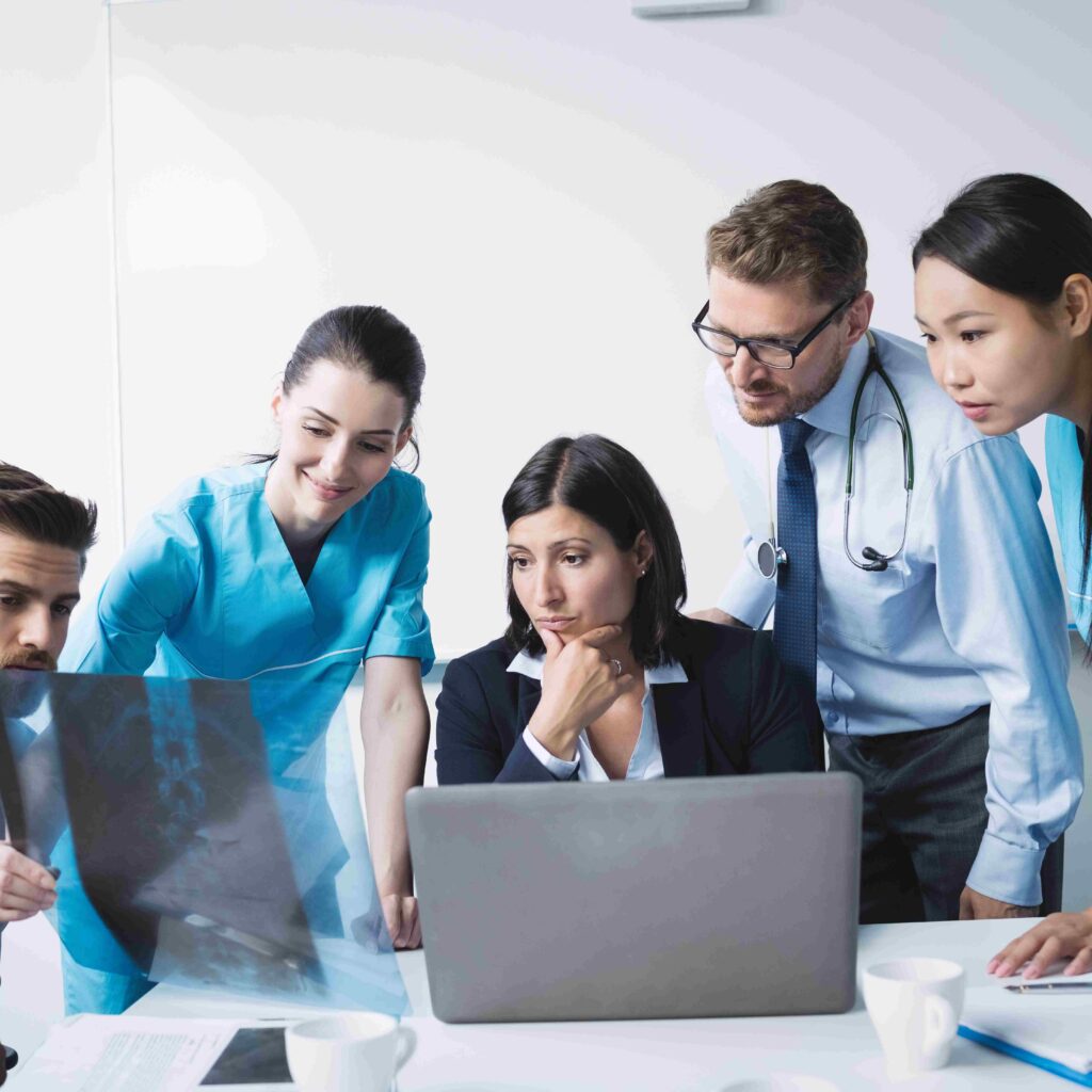 Medical team examining an x-ray report in conference room